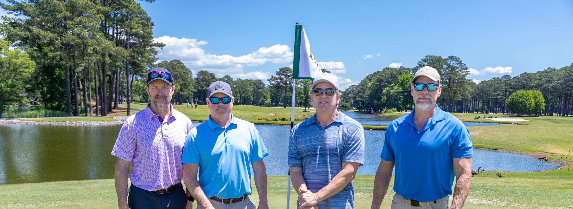 4 men on the golf green