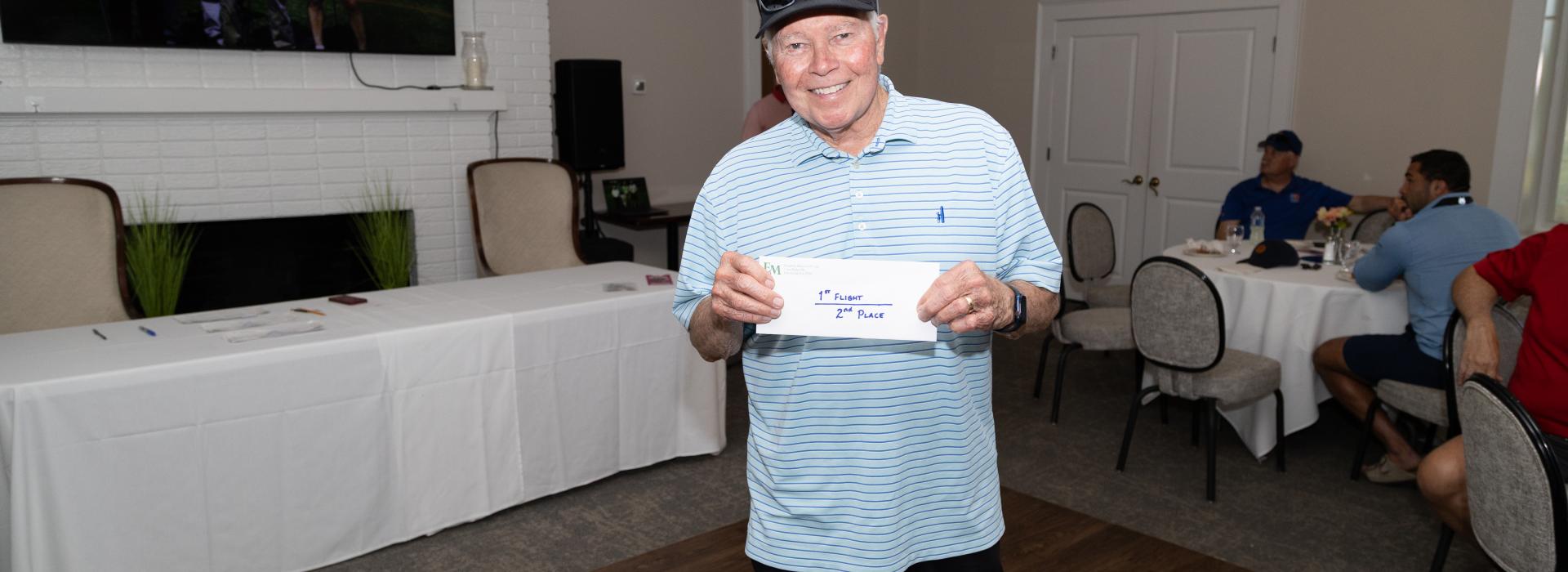 man holding an envelope in a golf club