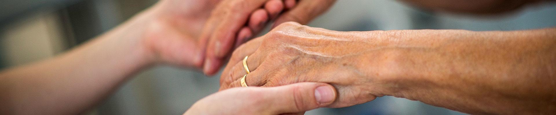 Close-up image of young hands holding older hands