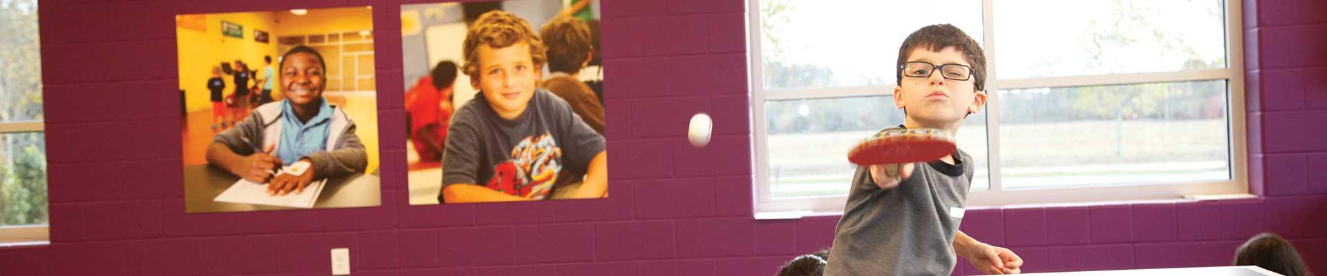 Boy playing ping pong at the YMCA