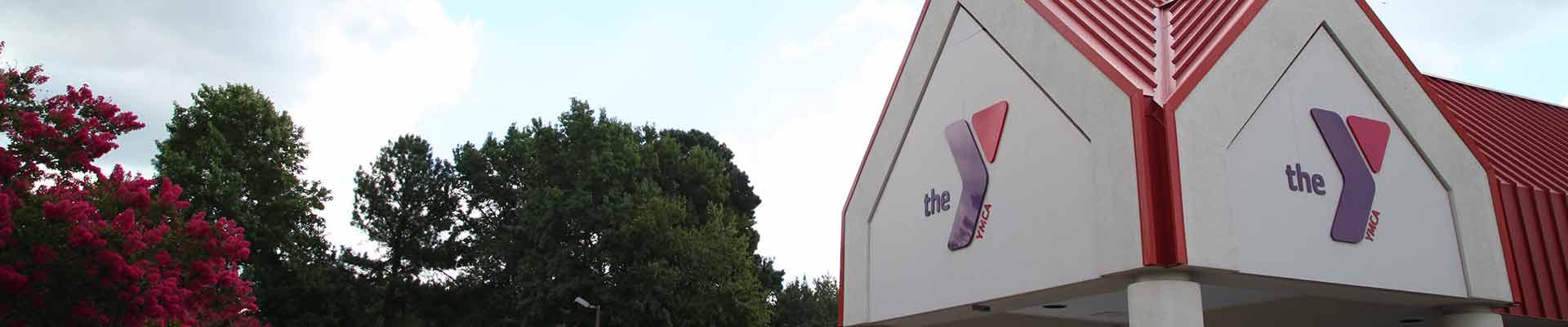 Background image of YMCA building with logo visible