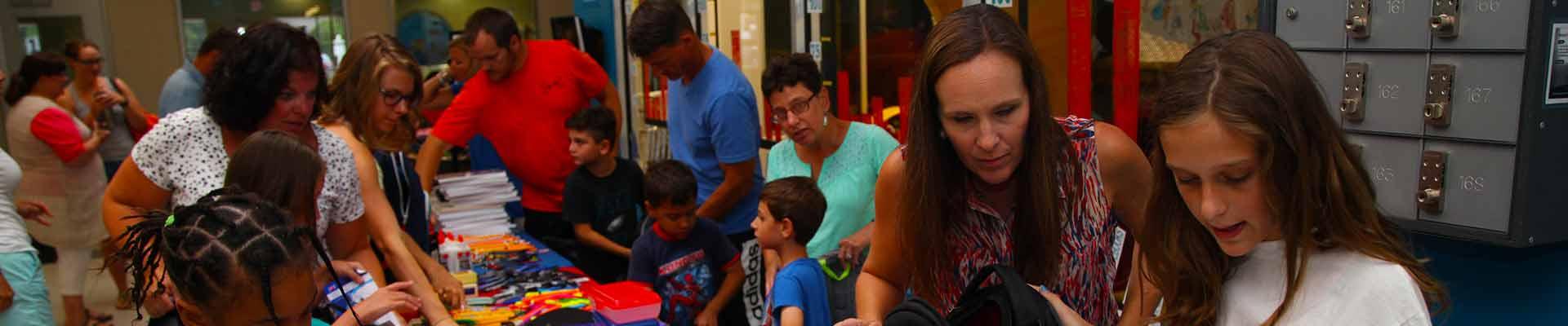 YMCA Togetherhood volunteers stuffing school supply bags
