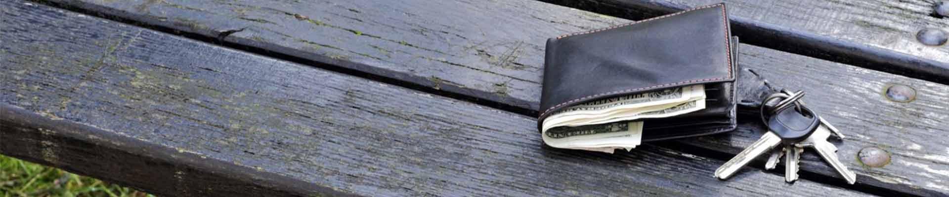 Wallet and keys resting on wooden surface
