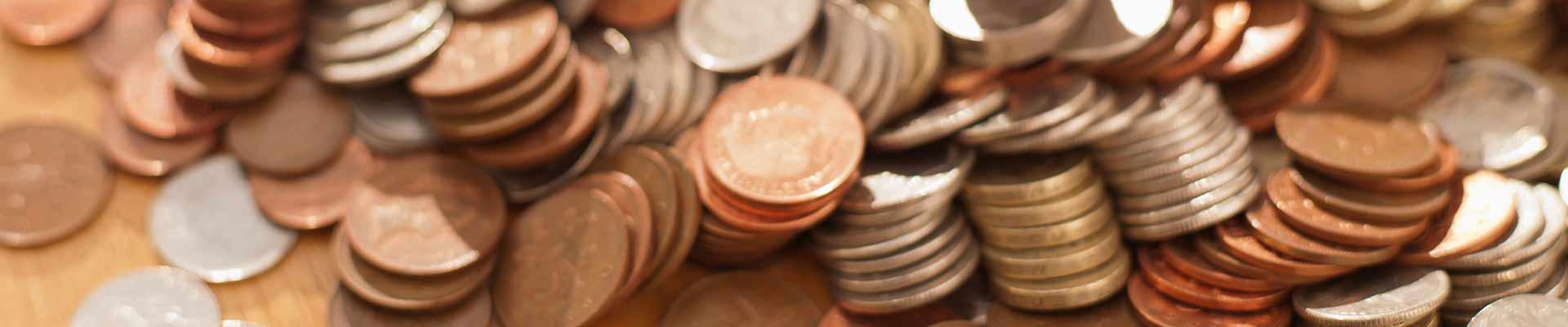 Background image of coins in stacks that have fallen over