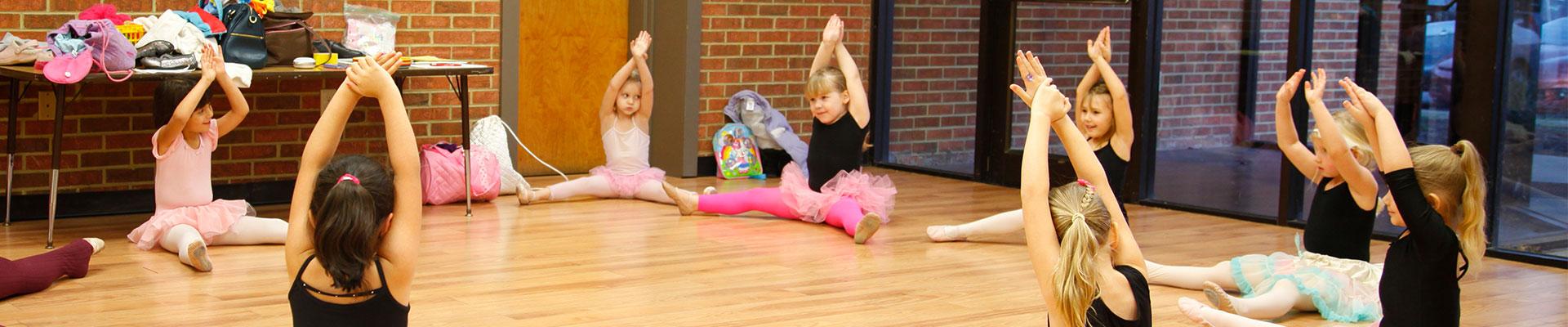 Young Ballet dancers stretching and warming up at the Y