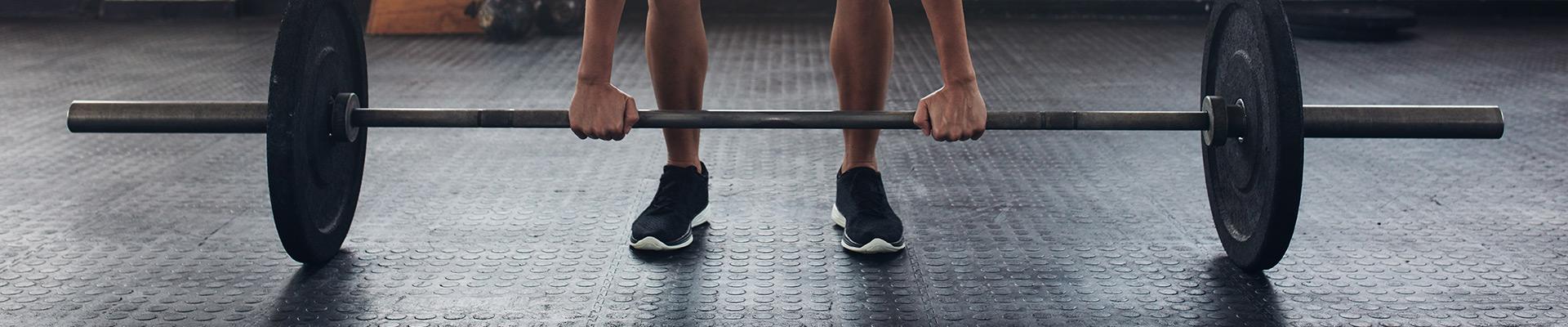 Woman deadlifting barbell