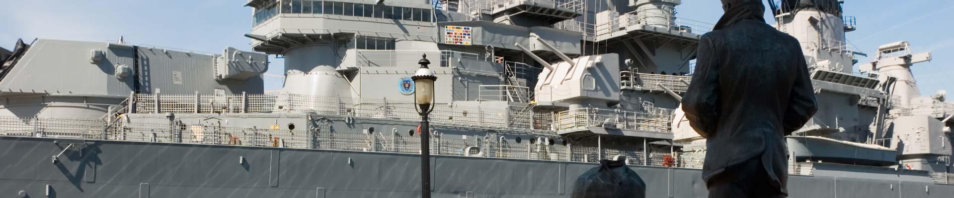 Navy ship with a statue in the foreground