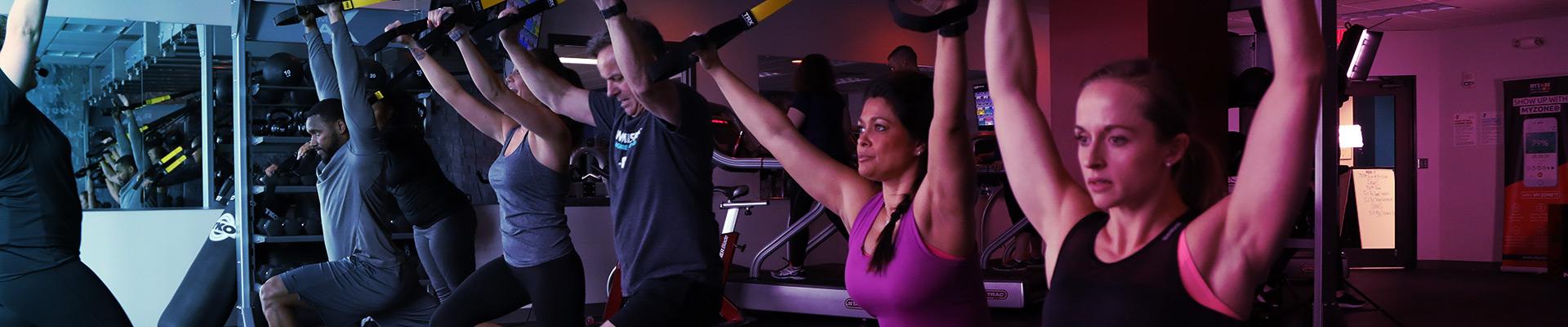 REGYMEN members working on the TRX Suspension System