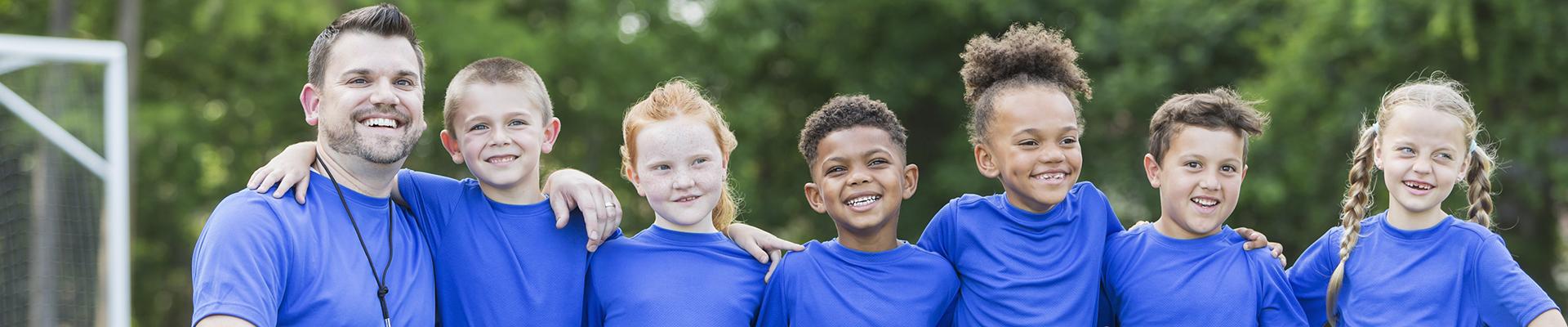 Youth Soccer Coach with team posing for group shot