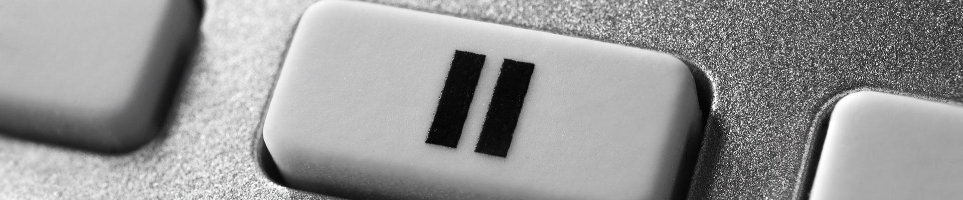 Image of a pause button against a silver background