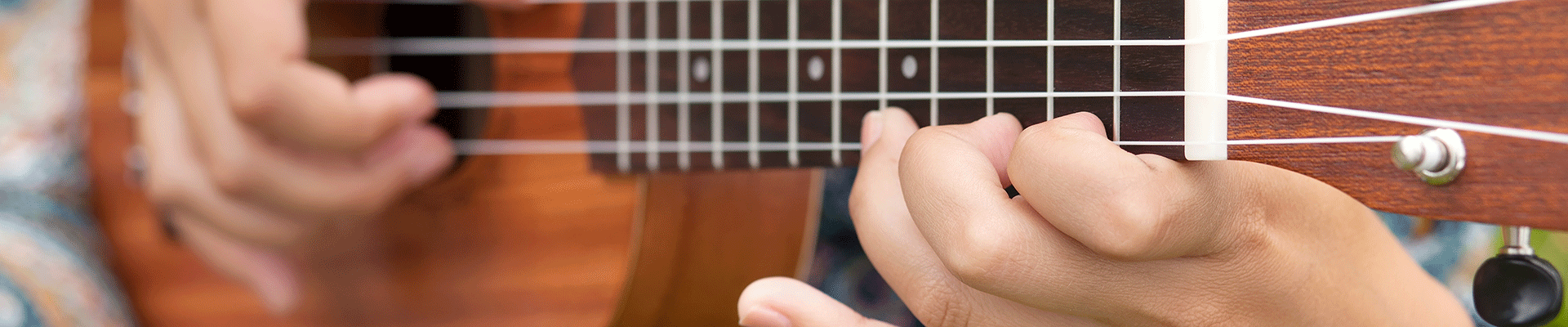 Hands holding a ukulele