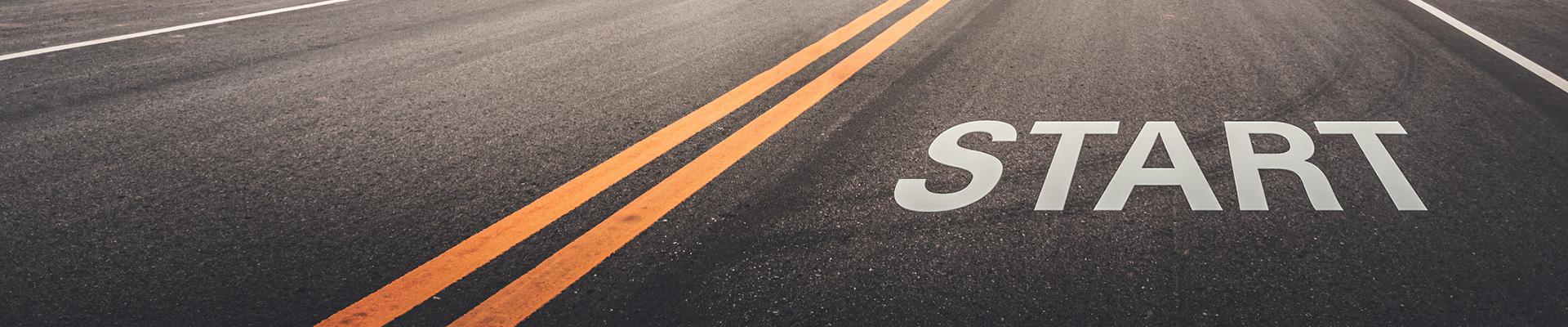 A road with the word "Start" painted on the pavement