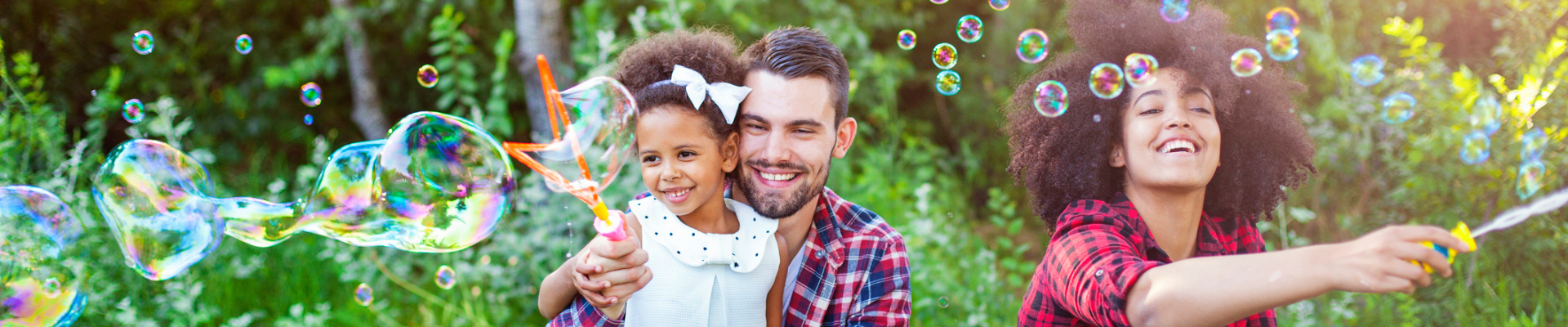 a family playing outside with bubbles