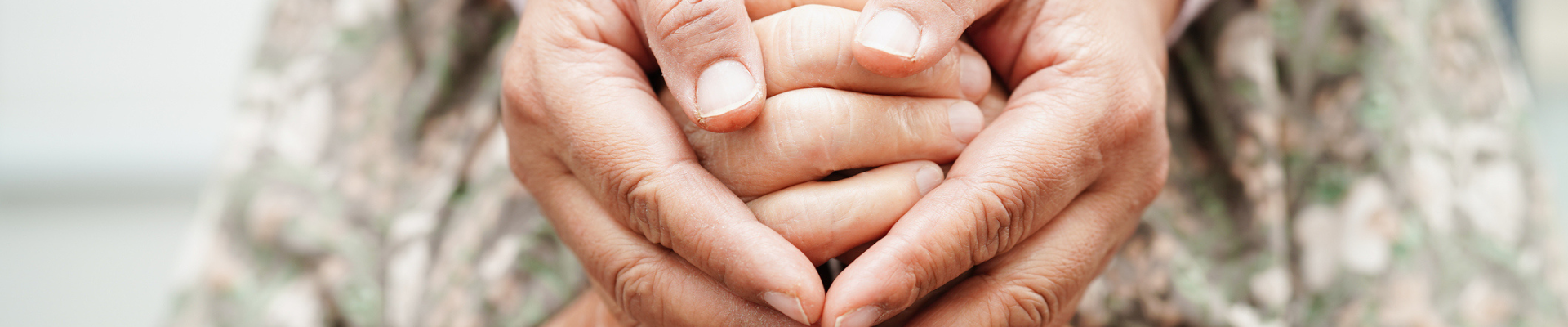 Caregiver holding hands elderly woman patient, help and care in hospital.