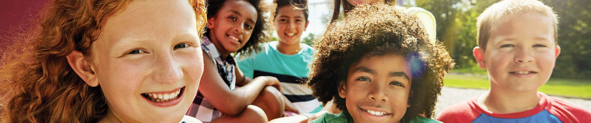 Children smiling at camera for healthy kids day initiative