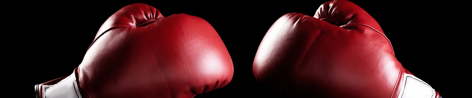 a pair of red boxing gloves with a black background