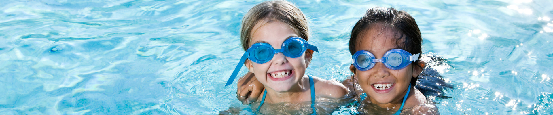 two girls smiling in swimming pool