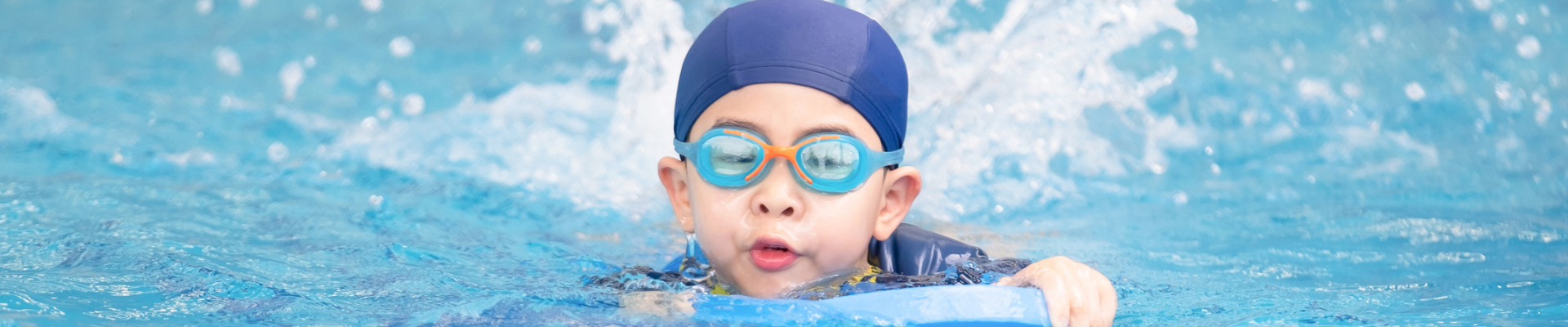 A little boy swimming in a pool