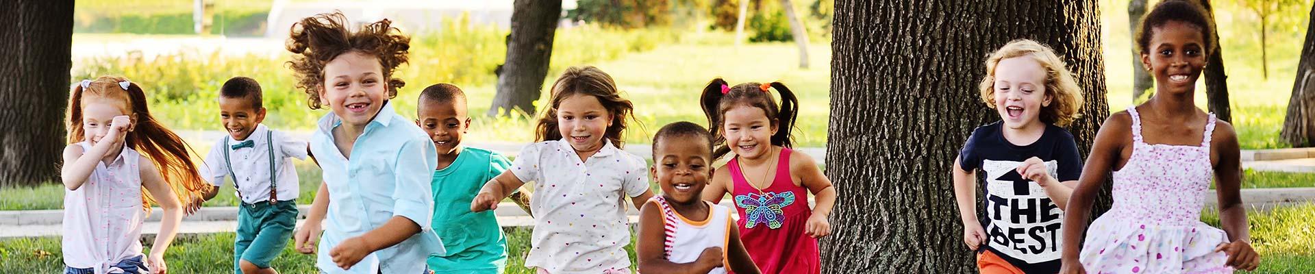 Preschool children running outside during summer.