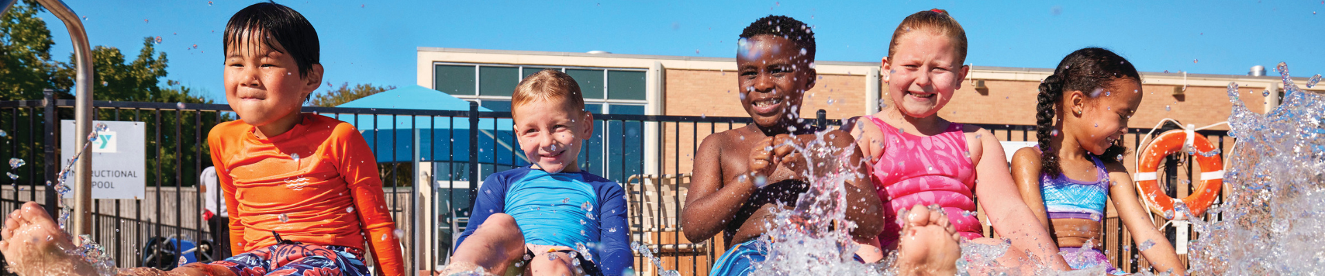 Kids at the YMCA pool splashing in the water