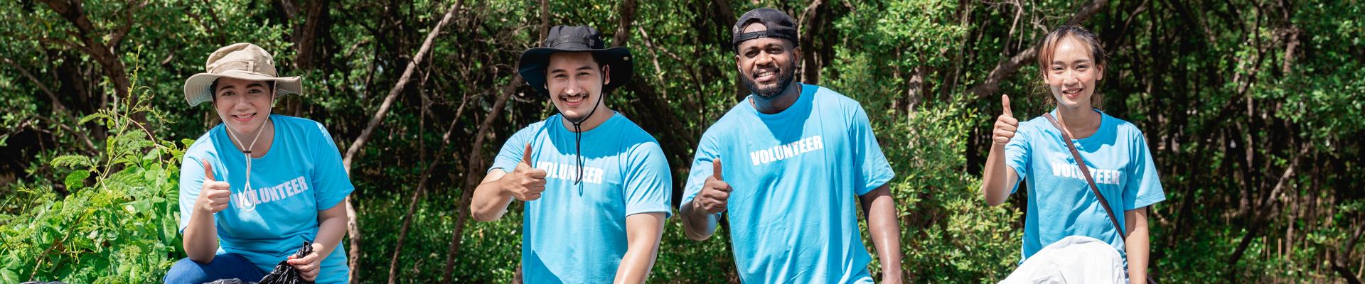 Community cleanup volunteers give the camera a thumbs up.