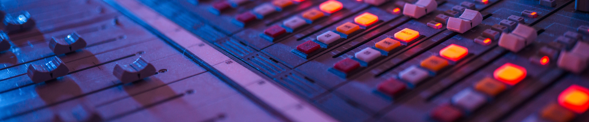 Purple lit studio mixing board panel