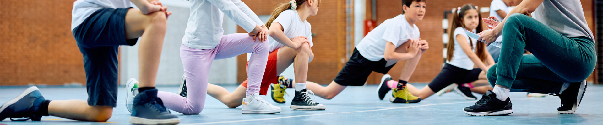 Kids stretching and working out in an indoor gym
