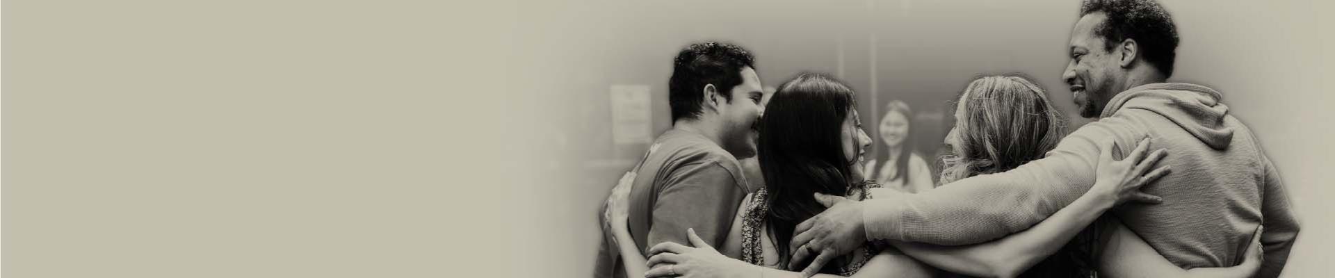 Sepia toned image of people hugging