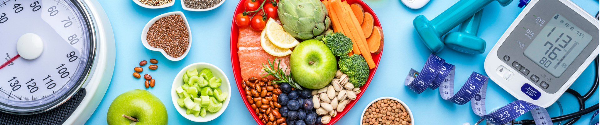 Healthy food, scales and fitness equipment bird's eye view with a teal background