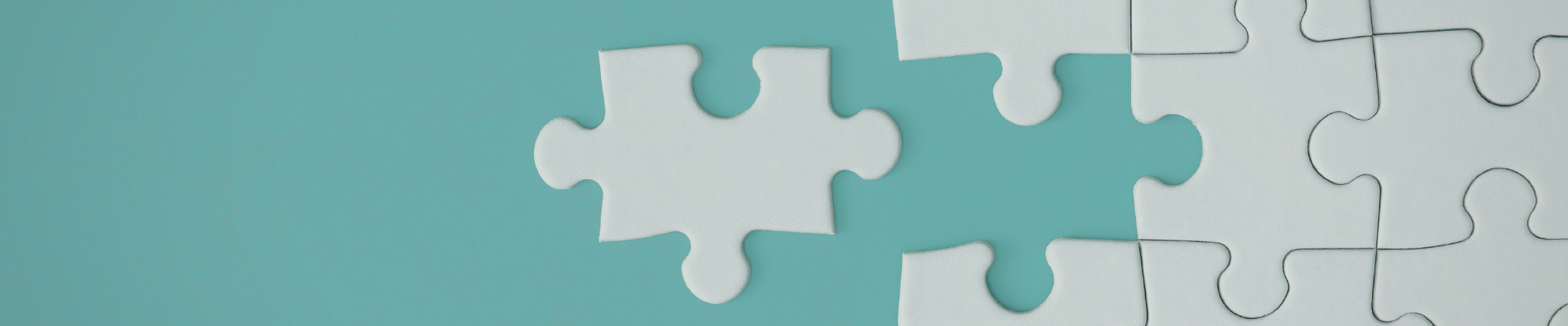 Teal background with white puzzle pieces