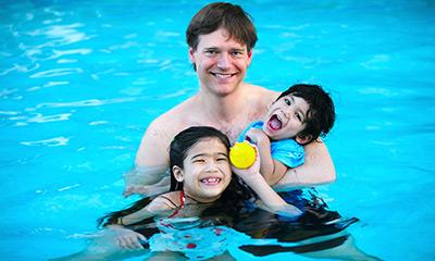 man swimming with kid