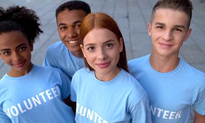 Group of teen volunteers smiling at the camera