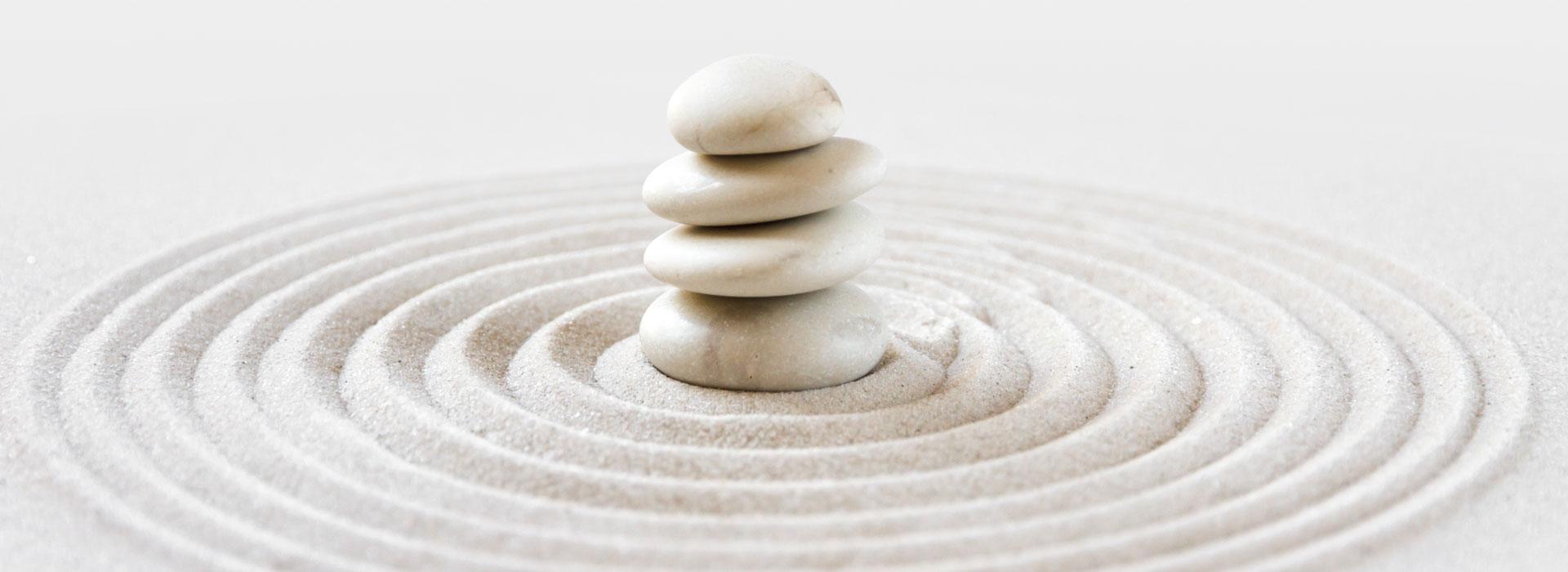Sand Zen Garden with pile of smooth river stones