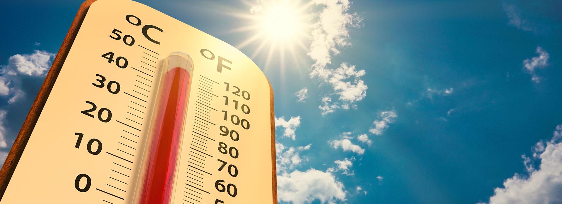 Background: blue sky with a few clouds and a bright sun. Foreground: Thermometer showing temps of 110 degrees.