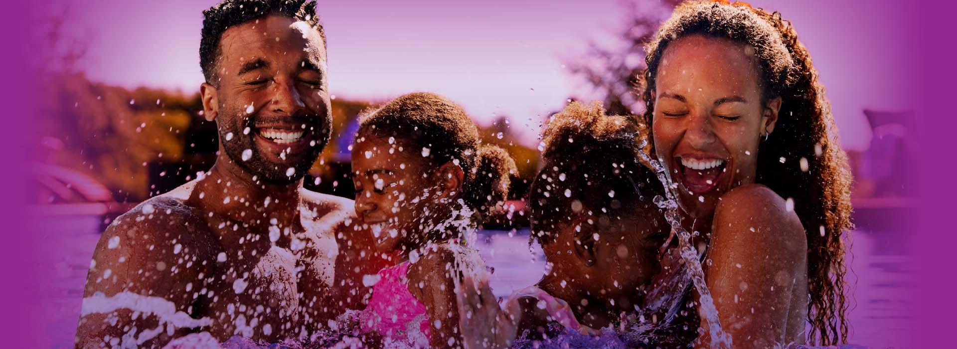 Family playing in the pool with a purple background