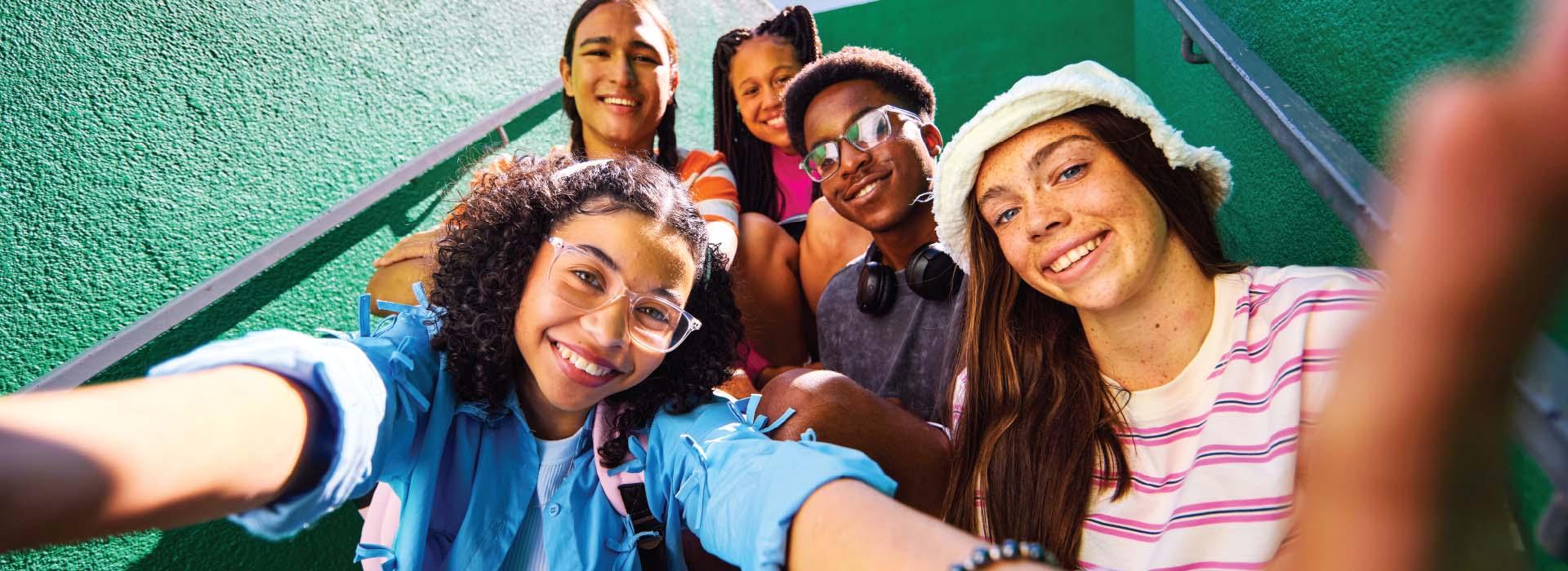 Teens on a stairwell taking a selfie