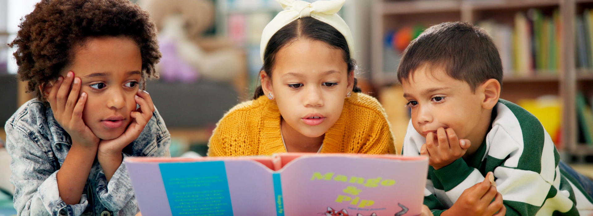 3 Kids reading a book